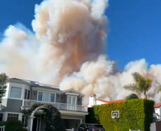 Wildfire sparks panicked evacuations in Los Angeles suburb