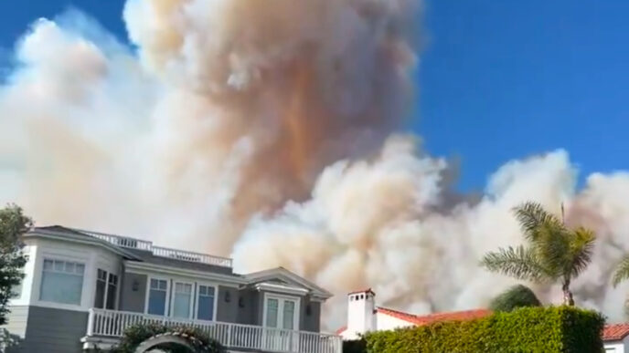 Wildfire sparks panicked evacuations in Los Angeles suburb